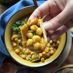 Eating with hands Amritsari Chole with wheat paratha .