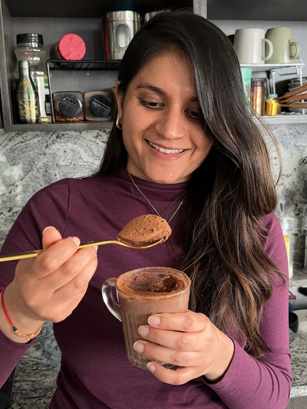 Jahnvi bio pic - holding paneer chocolate mousse in a glass and scooping with a spoon