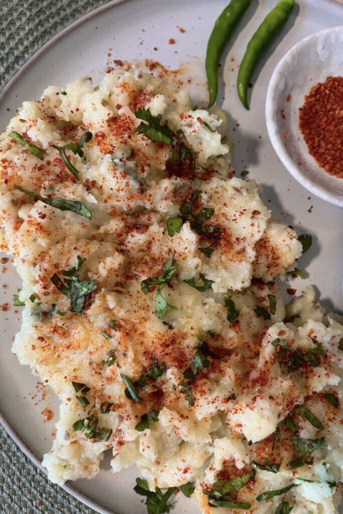 papdi no lot with achar masala sprinkled and coriander served with achar masala and a green chili for aesthetics