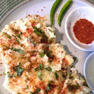 papdi no lot with achar masala sprinkled and coriander served with achar masala and a green chili for aesthetics
