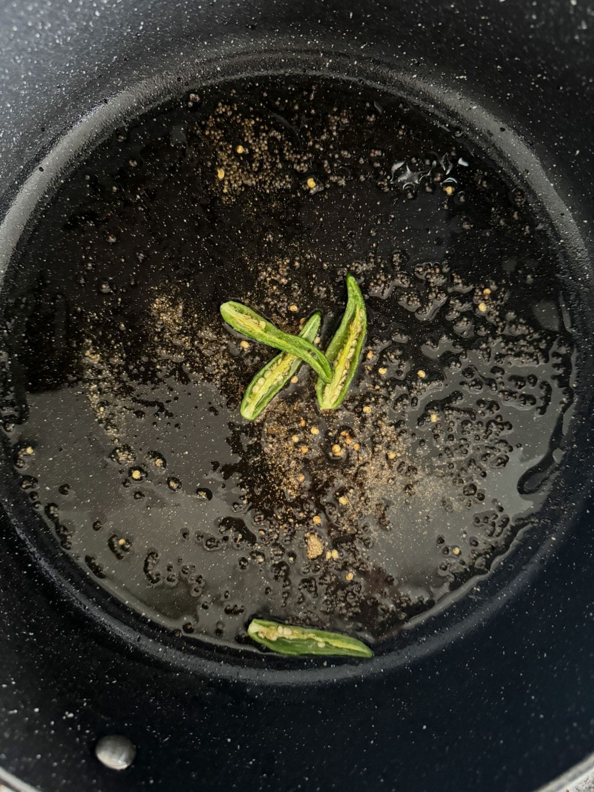 in a nonstick pan with tadka of rai, hing and green chillies