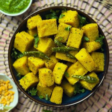 Vatidal khaman in a big bowl with chillies and a side of chutney and chana dal