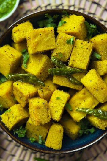 Vatidal khaman in a big bowl with chillies and a side of chutney and chana dal